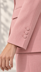 Close-up of light pink blazer sleeve cuff with three covered buttons | Beyond Formals
