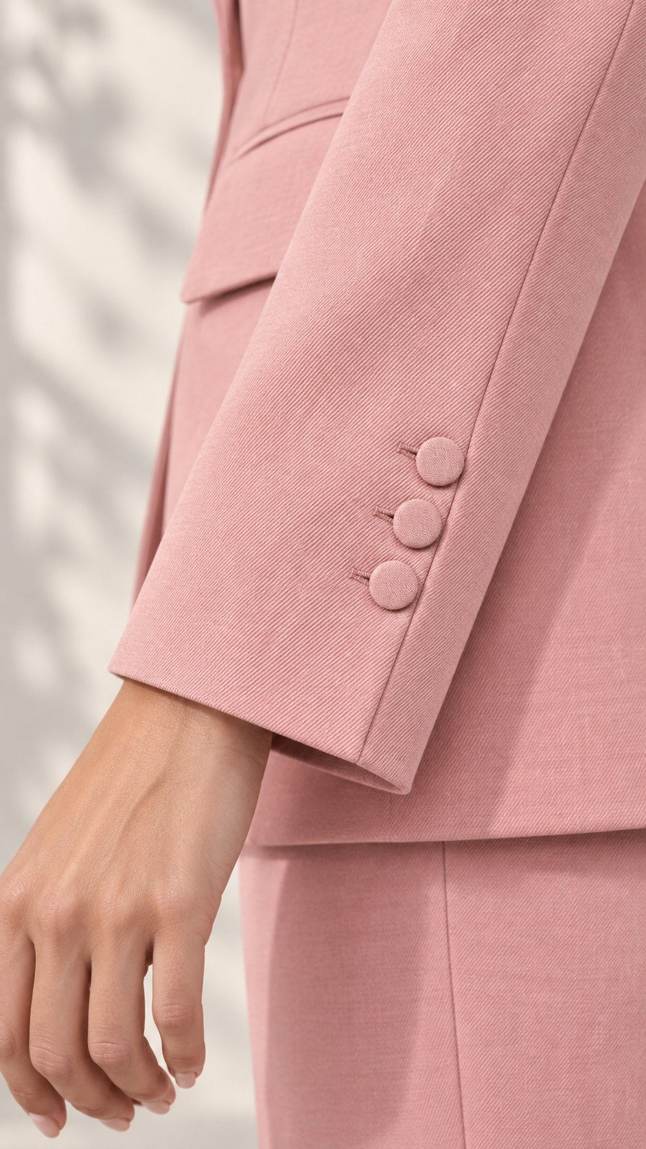 Close-up of light pink blazer sleeve cuff with three covered buttons | Beyond Formals