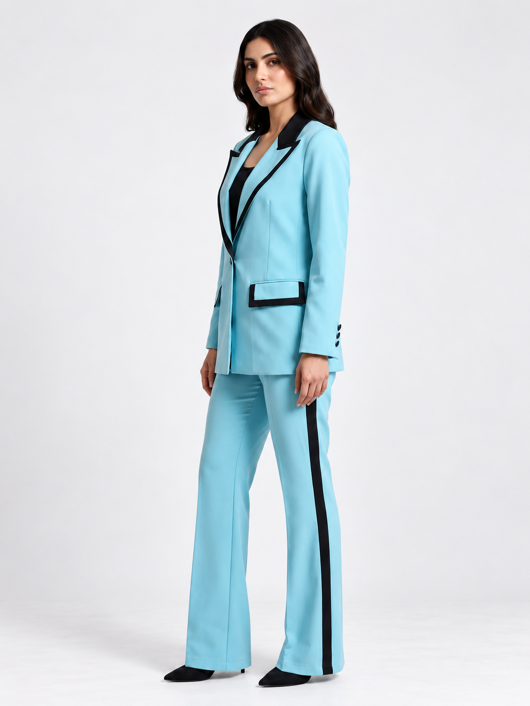 Sky blue blazer suit set with black contrast trim and side-stripe trousers on model, side view | Beyond Formals