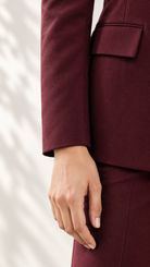 Maroon blazer close-up of clean sleeve finish and flap pocket | Beyond Formals