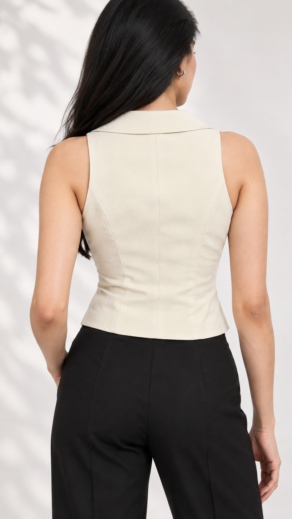 Back view of beige sleeveless tailored waistcoat with black straight-leg trousers | Beyond Formals
