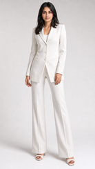 Woman wearing a white suit on a plain background