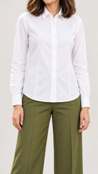 White shirt with classic collar tucked into olive green wide-leg trousers, close-up | Beyond Formals