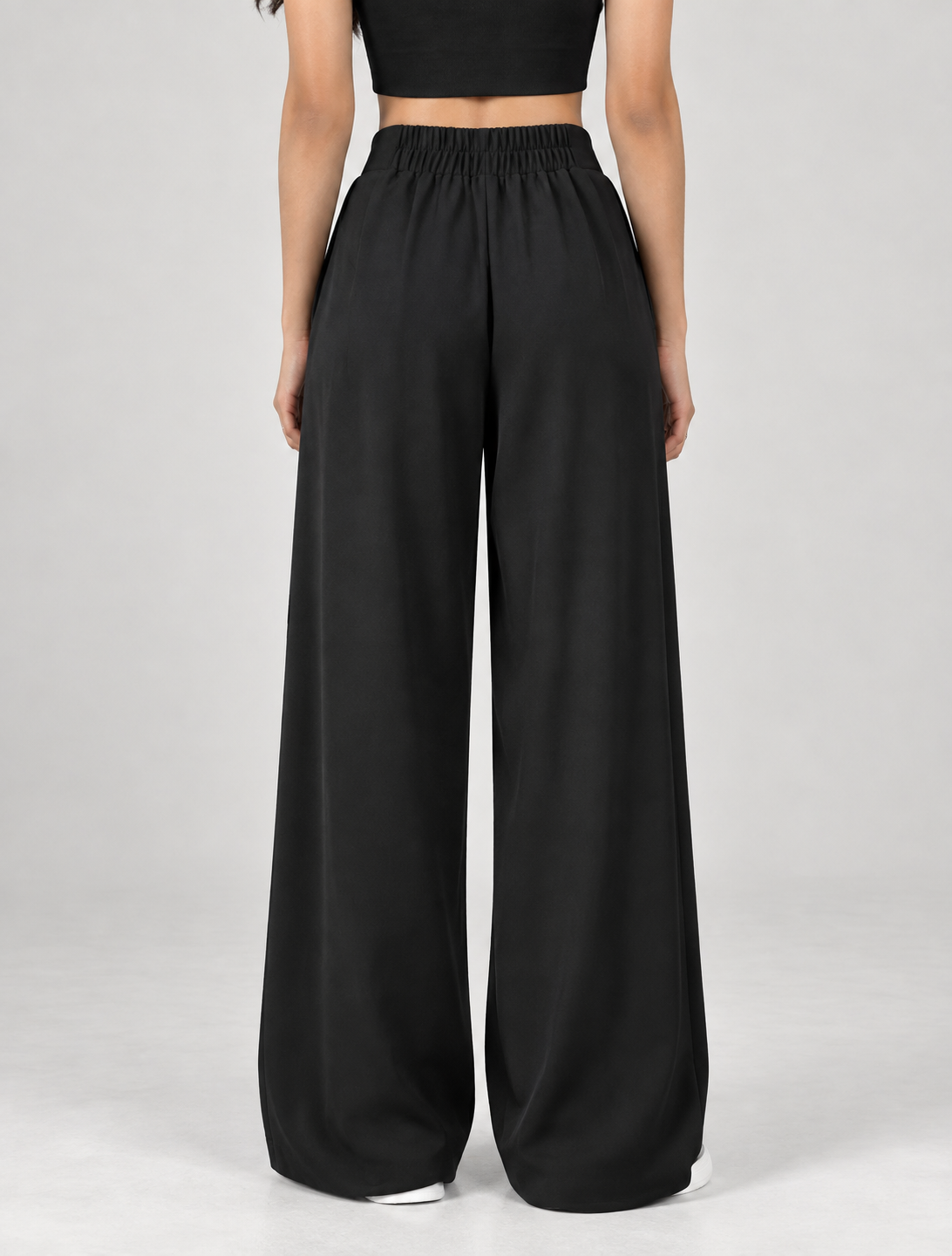 Black wide-leg formal trousers, back view showing elasticated waistband | Beyond Formals