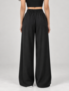 Black wide-leg formal trousers, back view showing elasticated waistband | Beyond Formals