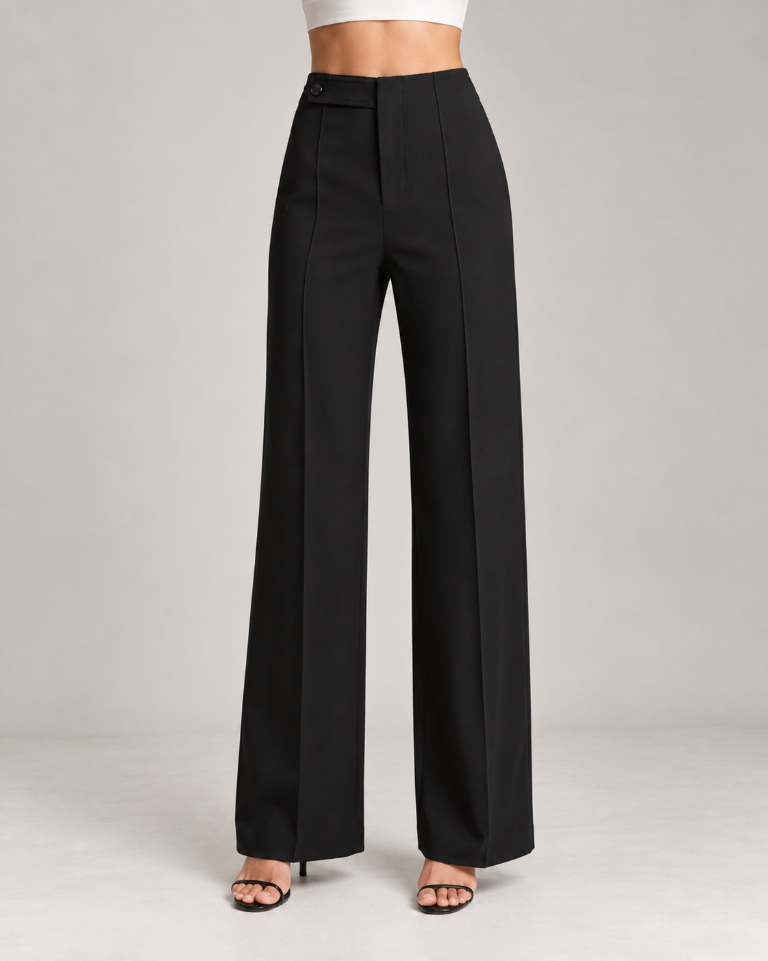 Black ultra high-waist trousers close-up of button tab waistband and front seam | Beyond Formals