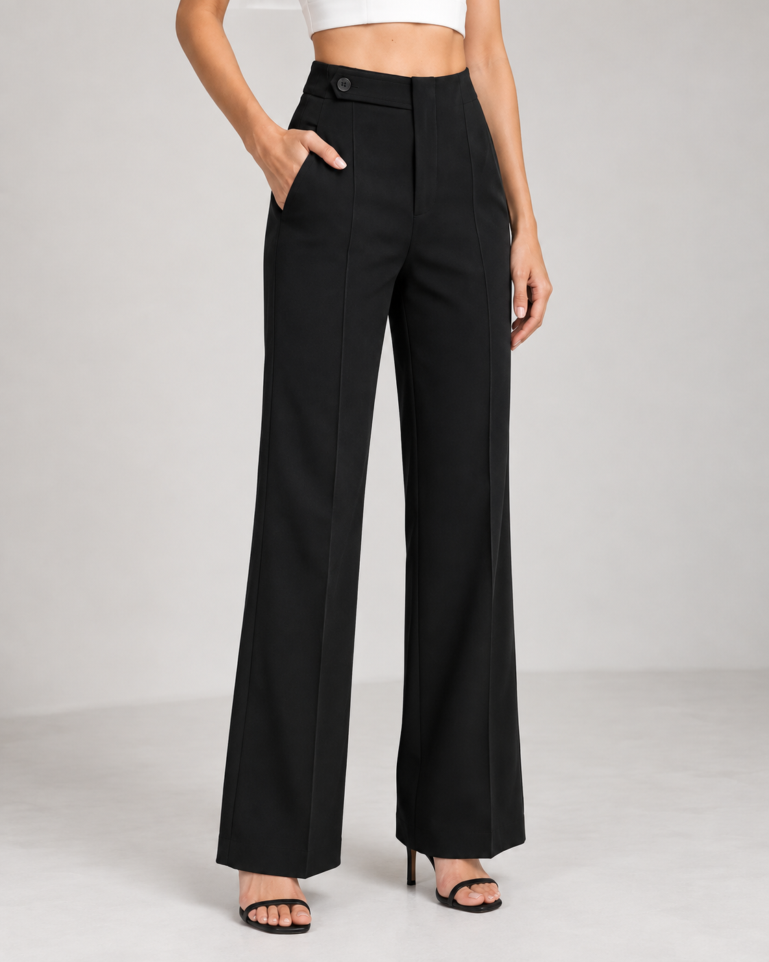Black ultra high-waist wide-leg trousers, side view with hand in pocket | Beyond Formals