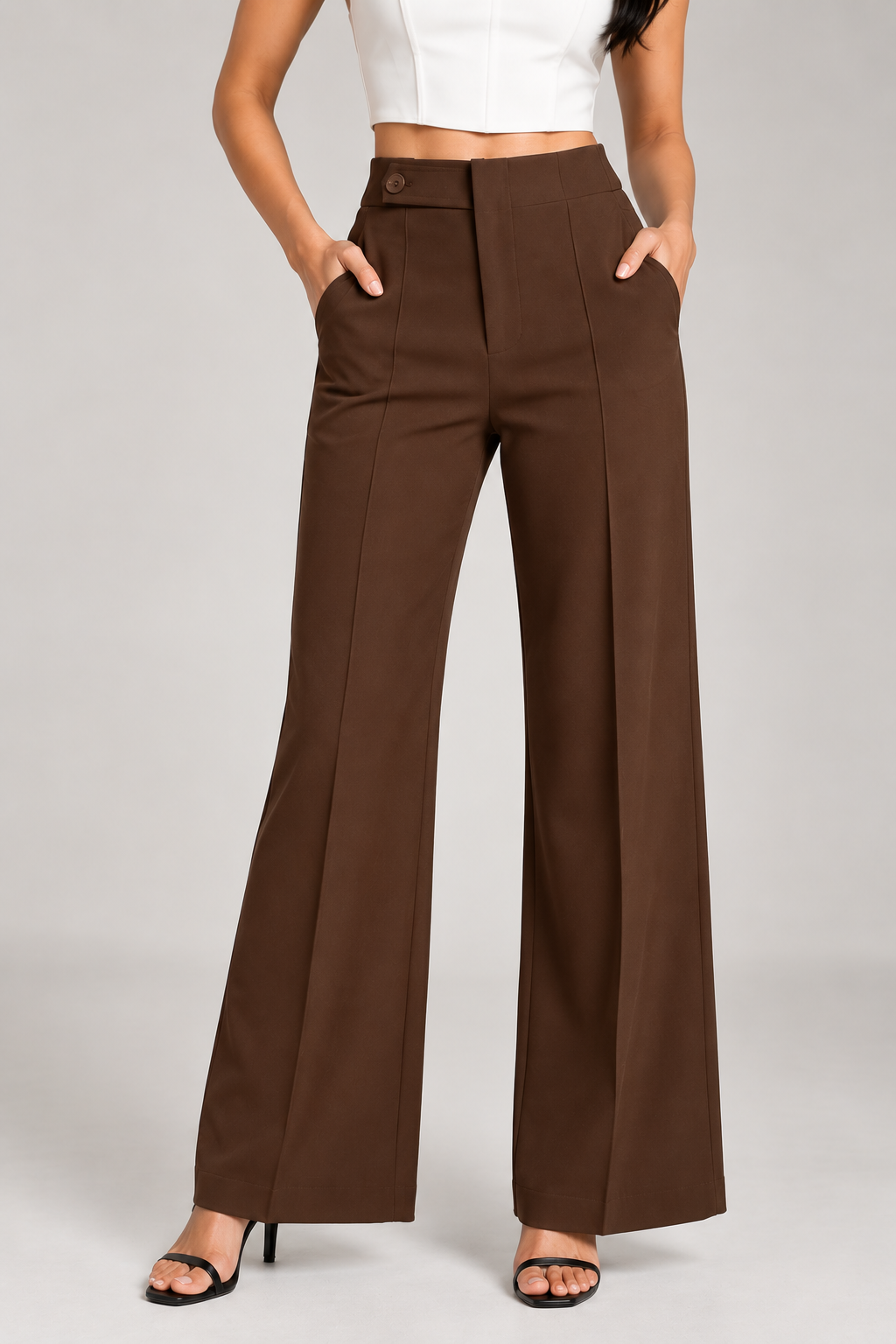 Brown ultra high-waist trousers close-up of button tab waistband, pockets and front seam | Beyond Formals