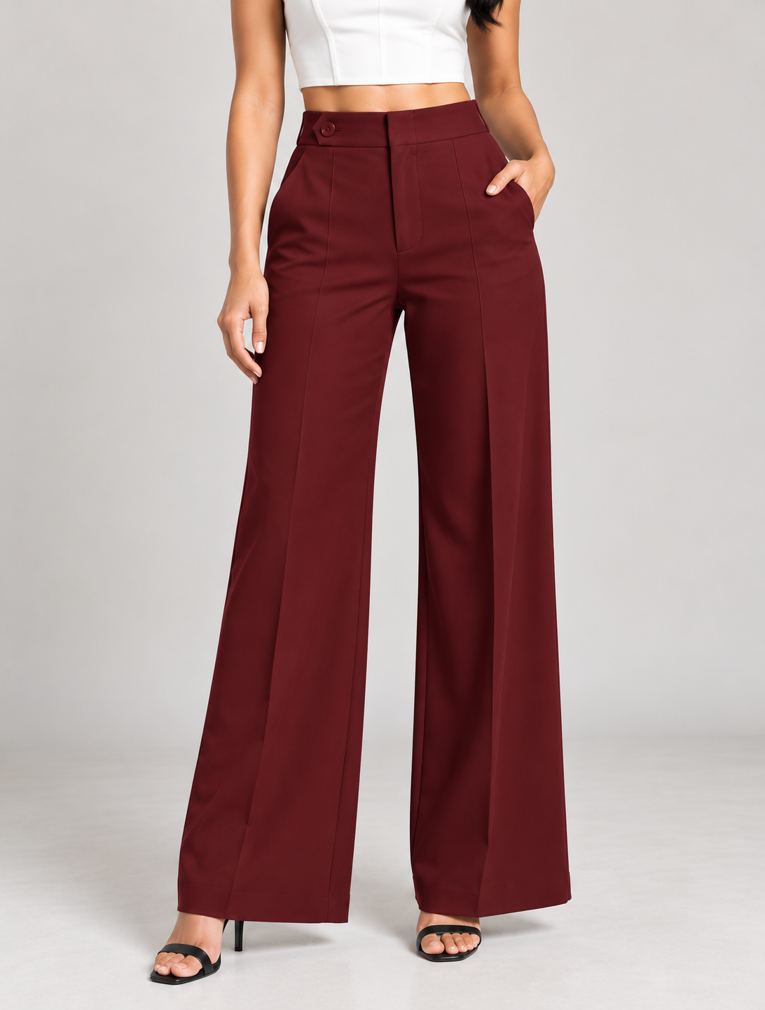Maroon ultra high-waist trousers close-up of button tab waistband and front seam | Beyond Formals