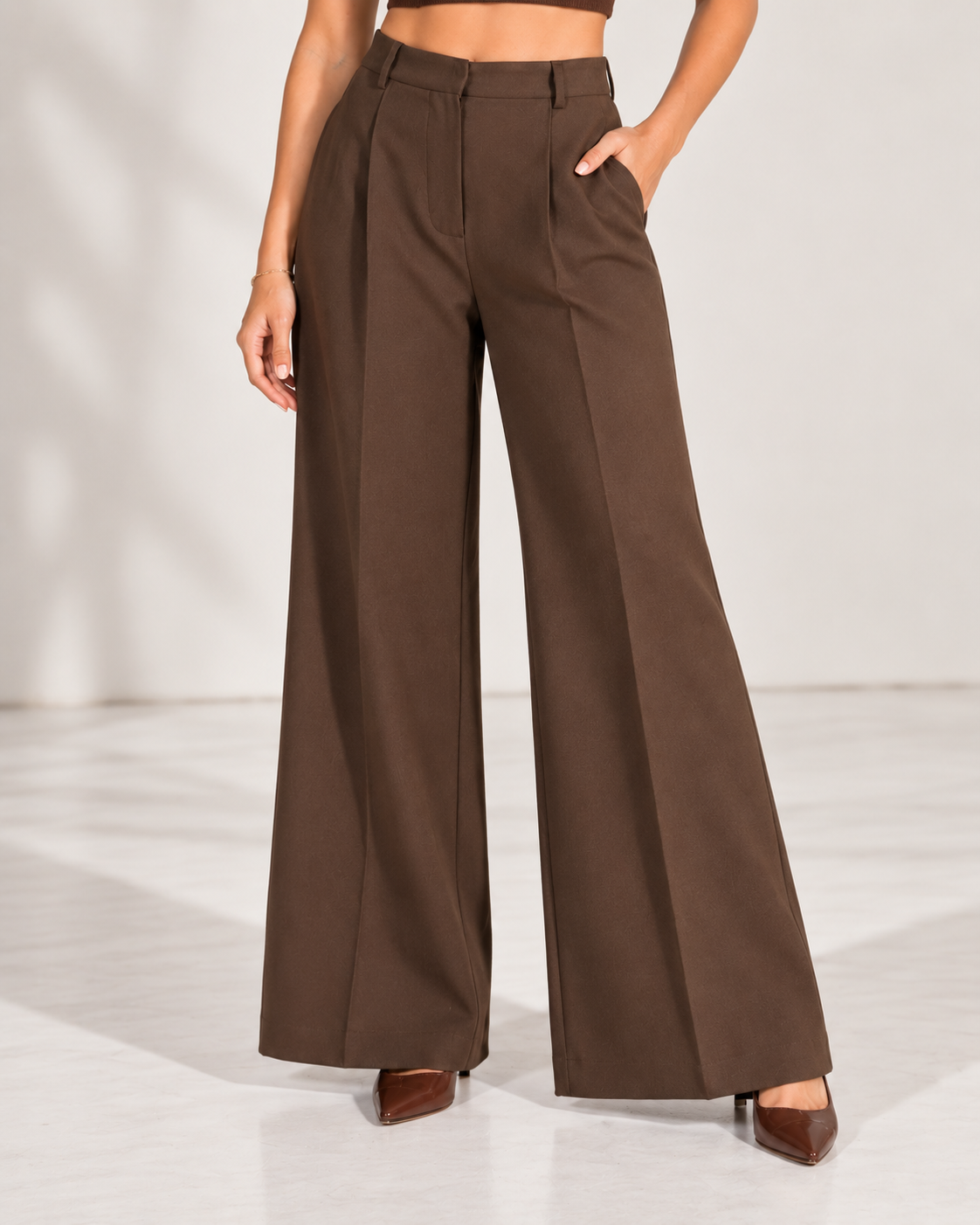 Brown wide-leg trousers, close-up of high waistband, belt loops, front pleats and pockets | Beyond Formals