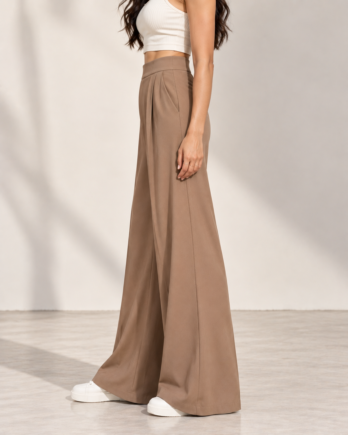 Beige pleated wide-leg trousers, side view showing fluid drape | Beyond Formals