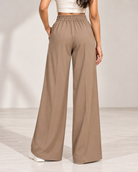Back view of beige wide-leg trousers showing elasticated waistband | Beyond Formals