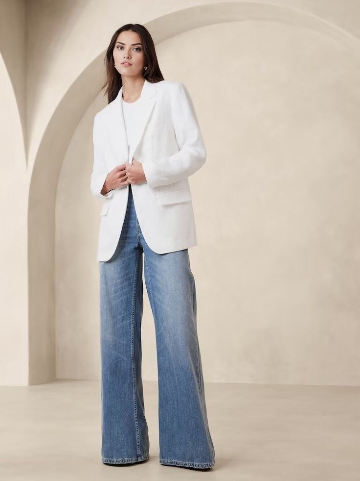 Women's white blazer with padded shoulders and a tailored fit.