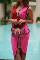 Women's red pink dress with a belted waist for formal dinners.