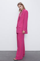 Pink oversized blazer suit set with high-waisted wide leg trousers.