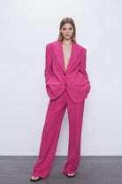 Pink oversized blazer suit set with high-waisted wide leg trousers.