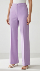 Person wearing lavender wide-leg pants on a white background