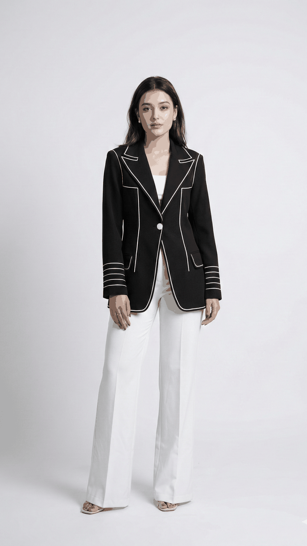 Black Signature Line blazer with white piping and striped cuffs, with white trousers, front view | Beyond Formals