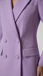 Purple coat with button details on a plain background