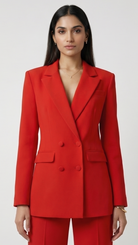 Woman wearing a red suit against a white background