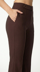 Brown pants worn by a person on a white background