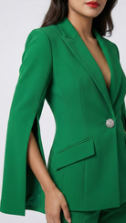 Green blazer with a brooch on a white background