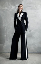 Women's black tailored blazer suit set with wide leg trousers for office wear.