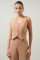 Women's peach button waistcoat with a structured silhouette.