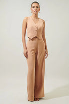 Women's peach button waistcoat with a structured silhouette.