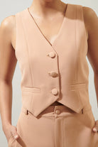 Women's peach button waistcoat with a structured silhouette.