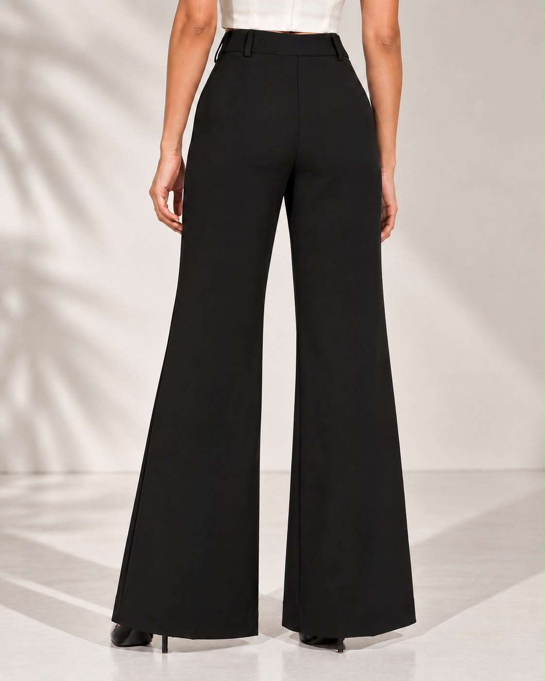 Black high-rise flared trousers, back view showing waistband and flare | Beyond Formals