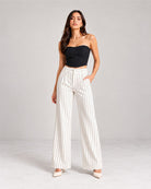 White pinstripe high-waist wide-leg trousers with black corset top, full-length front view | Beyond Formals