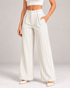 White pinstripe trousers styled with a cream crop top, close-up of waist and pockets | Beyond Formals